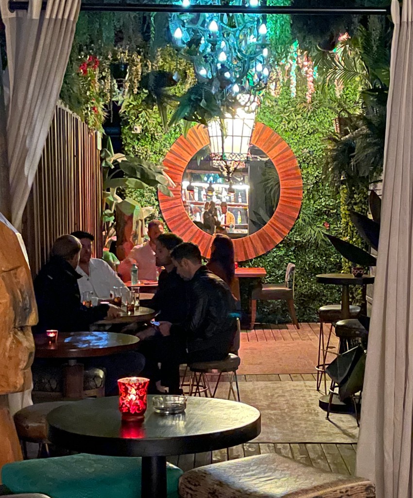 The Champagne Garden — living green walls, lantern and candlelit courtyard