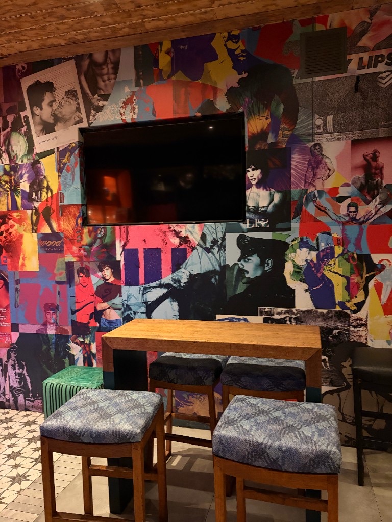 Crew Bar seating area with collage mural