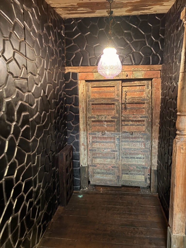 Hallway leading to antique chained double doors